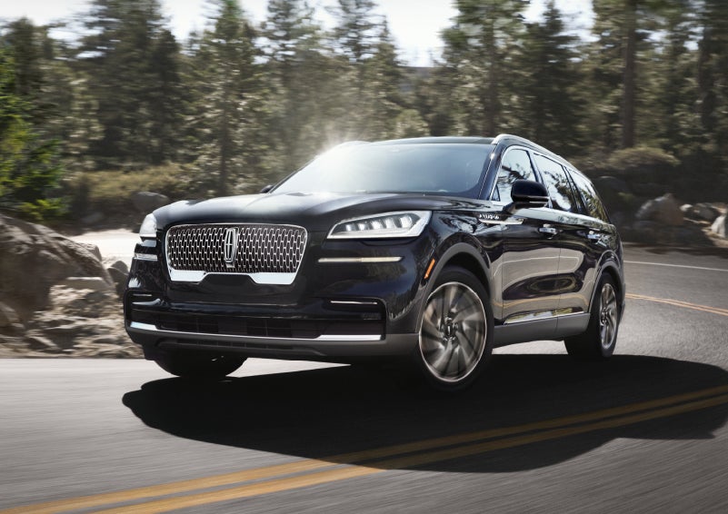 A Lincoln Aviator® SUV is being driven on a winding mountain road | White's Canyon Motors - Lincoln in Spearfish SD