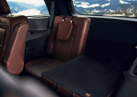 The left rear seat of a 2024 Lincoln Aviator® SUV is shown folded flat for additional cargo space | White's Canyon Motors - Lincoln in Spearfish SD