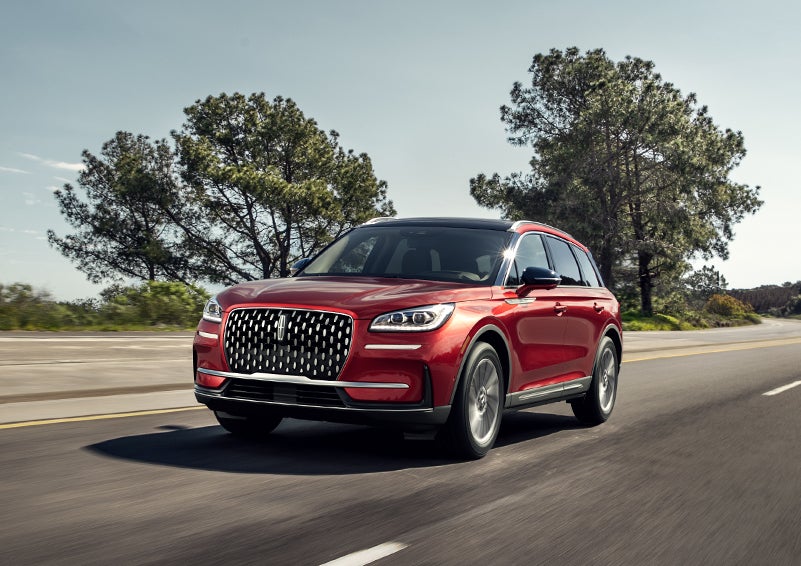 A 2024 Lincoln Corsair® SUV is shown being driven on a country road. | White's Canyon Motors - Lincoln in Spearfish SD