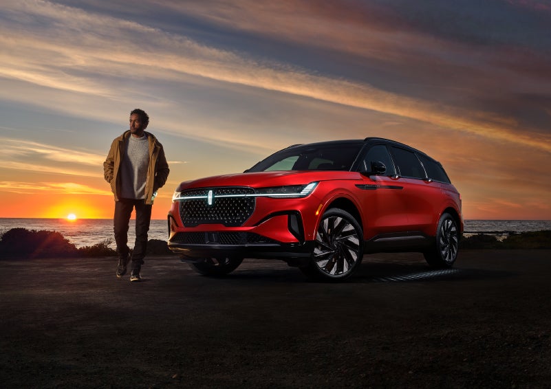 A person is shown next to a 2024 Lincoln Nautilus® SUV as the Lincoln Embrace sequence takes place. | White's Canyon Motors - Lincoln in Spearfish SD